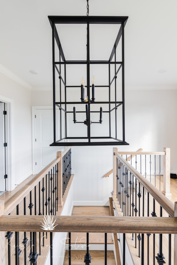 Interior photography of Iron Chandelier hanging over stairwell
