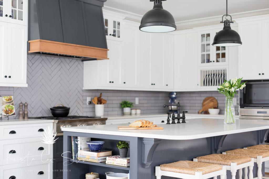 Interior photography of Gray and White kitchen featuring subway tile, gray island and barstools.