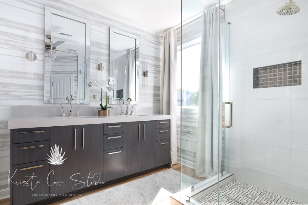 Beautiful modern double vanity and glass shower featured in master bathroom.