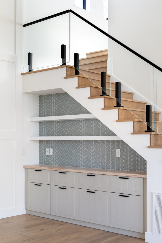 Built-in cabinetry under the stairs with tile accent